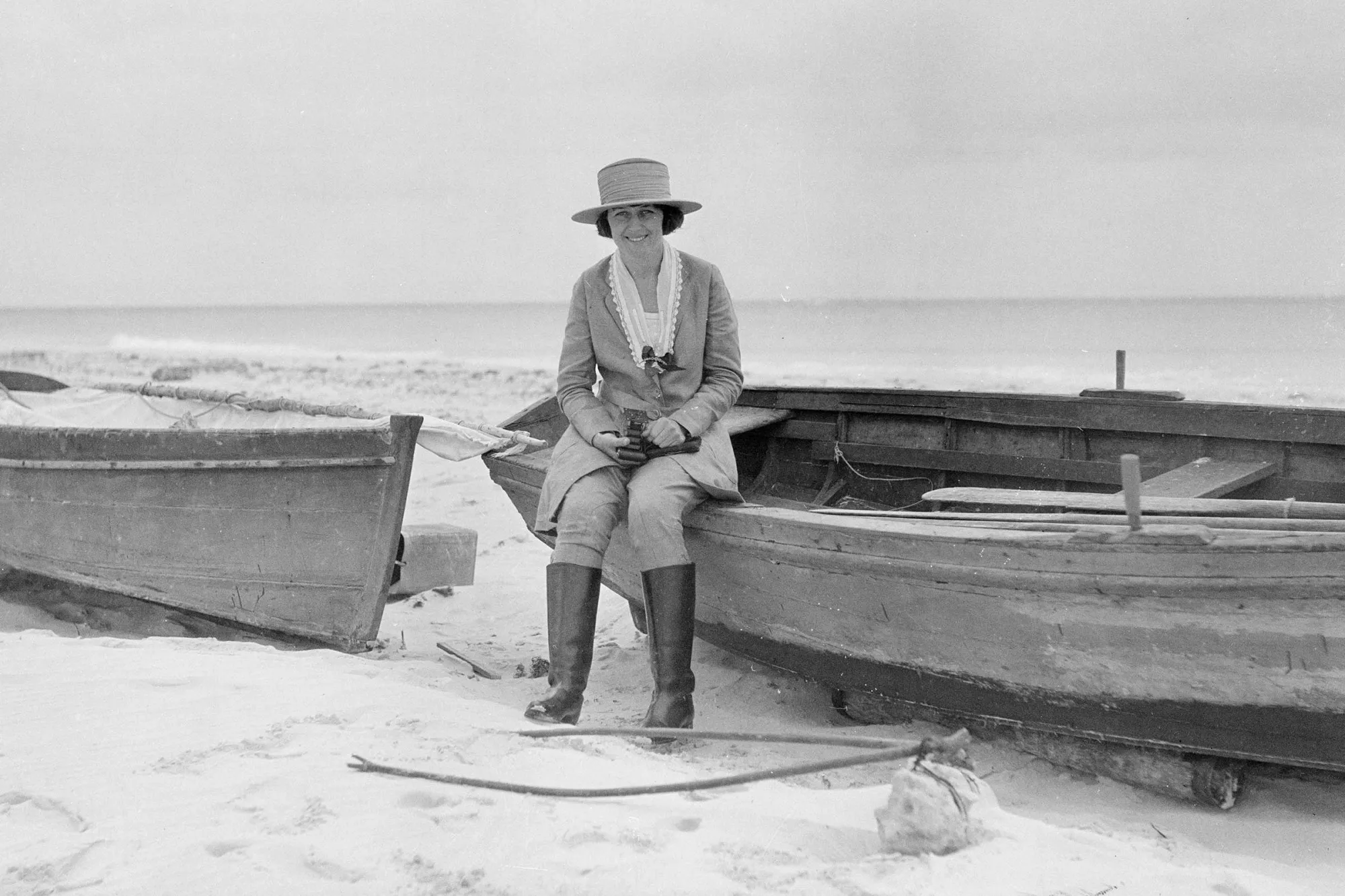 Ethel Herzfeld sitting on a boat on the beach